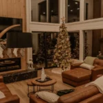 Cozy Christmas living room with a decorated tree beside a lit fireplace