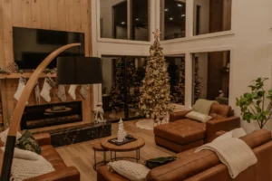 Cozy Christmas living room with a decorated tree beside a lit fireplace