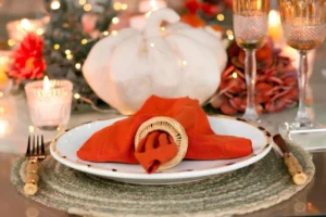 Fall table with pumpkin decor in warm candlelight