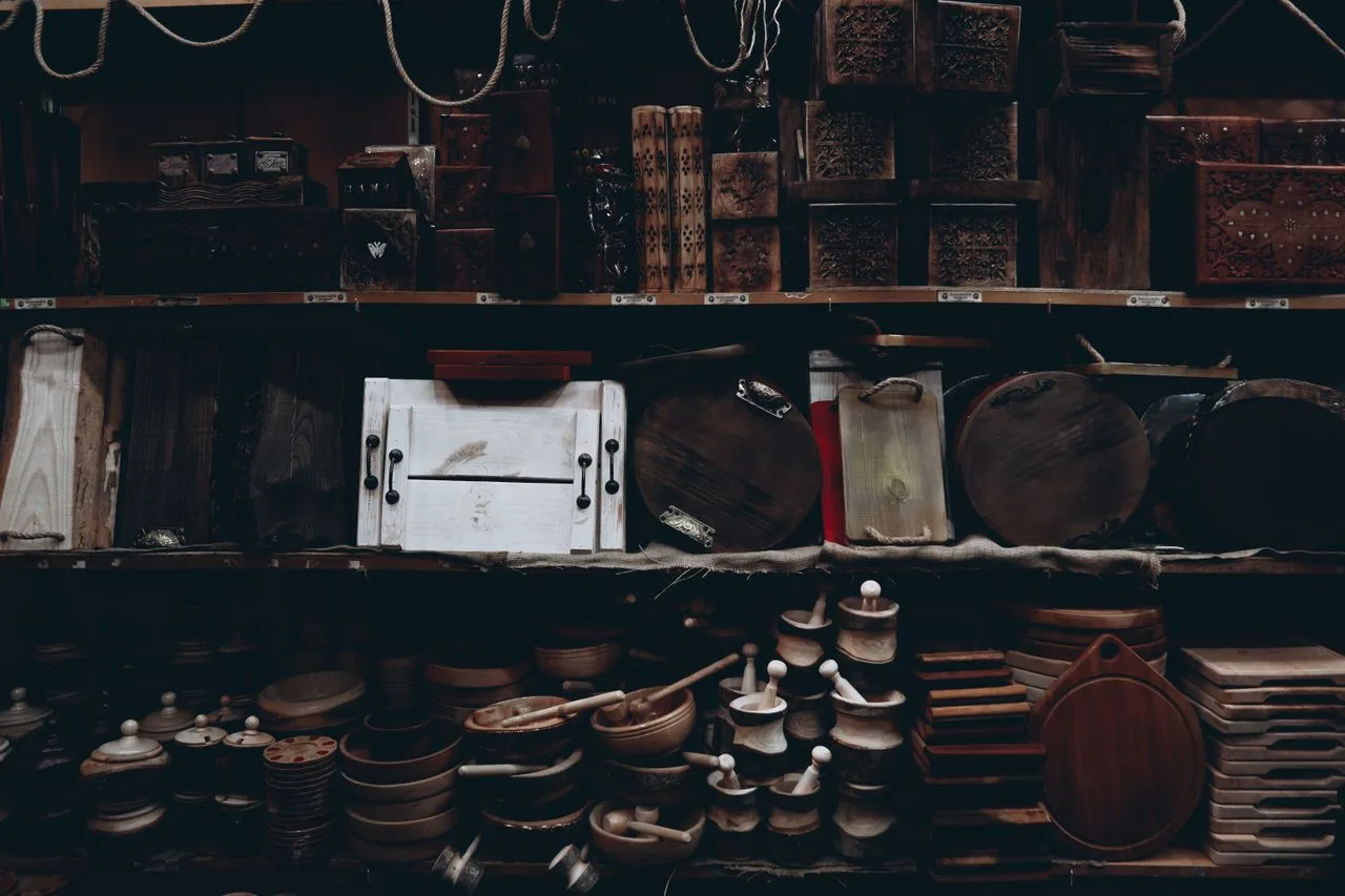 Wooden bowls and kitchenware displayed on open shelves